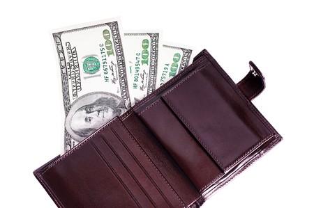 Banknotes dollars in leather brown purse isolated on whiteの写真素材
