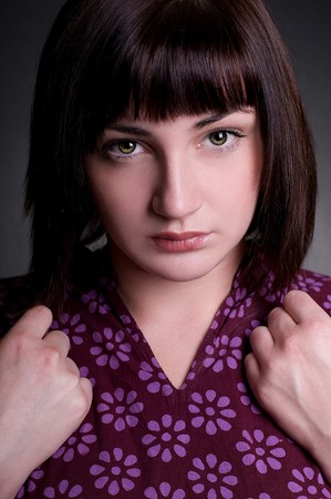 Beautiful serious girl holds hands on shouldersの写真素材