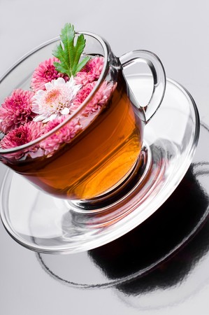 cup of herbal tea with flowers on black の写真素材