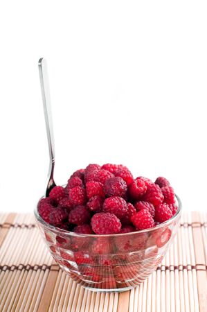 ripe raspberry in a dish with spoonの写真素材