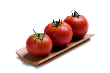 ripe tomatoes isolated on whiteの写真素材