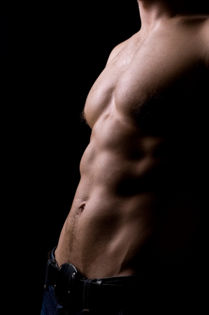 torso of strong athletic man on blackの写真素材