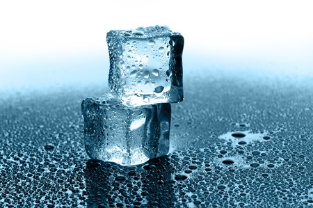 wet ice cubes on black glossy backgroundの写真素材