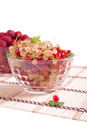 Fresh Raspberry and currant in a crystal bowl isolatedの写真素材