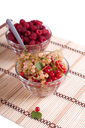 Fresh Raspberry and currant in a crystal bowl isolatedの写真素材