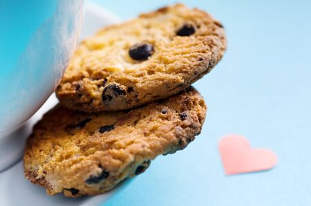 Chocolate homemade pastry biscuits on blue background with heartの写真素材