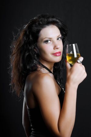 Beautiful girl with wine glass on blackの写真素材