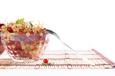 Fresh Raspberry and currant in a crystal bowl isolatedの写真素材