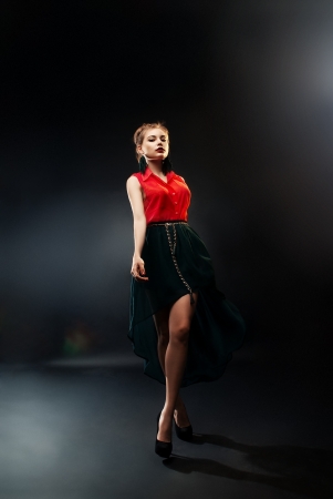 young woman on dark backgroundの写真素材