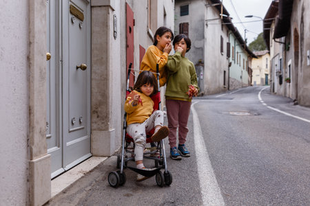 three girls talking standing outsideの写真素材