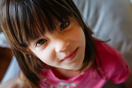 smiling girl with long hair watching at cameraの写真素材