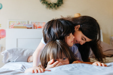 pyramid of three smiling girls lying on each otherの写真素材
