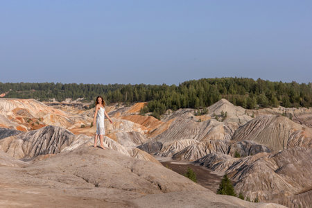 A beautiful woman on the background of landscape.Top view of the quarryの写真素材