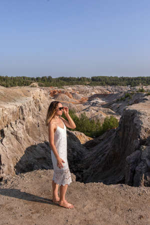 A beautiful woman on the background of landscape.Top view of the quarryの写真素材