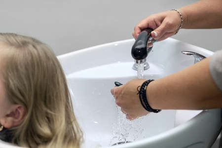 The hairdresser is going to wash the clients hairの写真素材