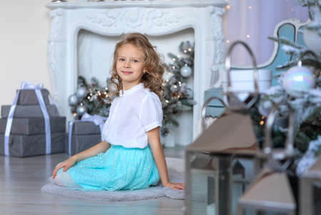 A girl surrounded by Christmas decorations and giftsの写真素材