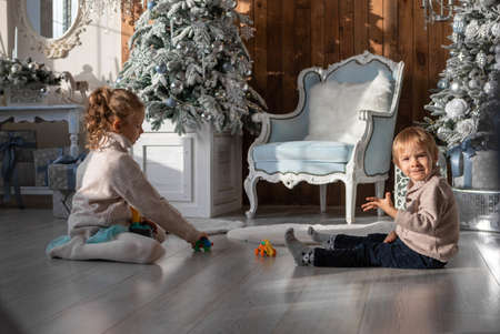 Brother and sister play on the floor in a New Year atmosphereの写真素材