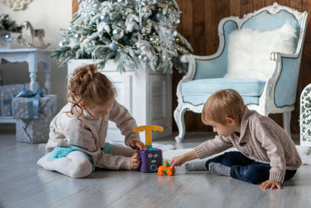 Brother and sister play on the floor in a New Year atmosphereの写真素材