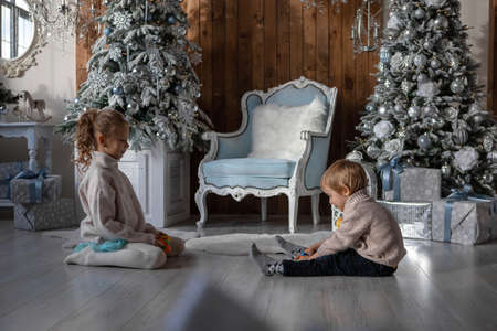 Brother and sister play on the floor in a New Year atmosphereの写真素材