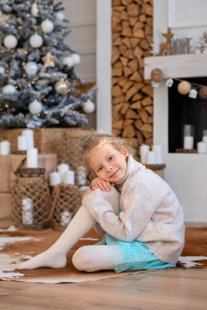 A child on the background of a Christmas tree, gift boxesの写真素材