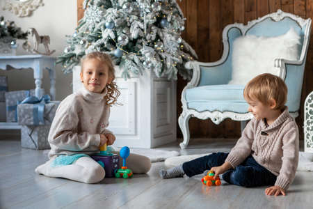 Brother and sister play on the floor in a New Year atmosphereの写真素材
