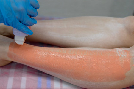 The master applies wax to the skin with a special device.の写真素材