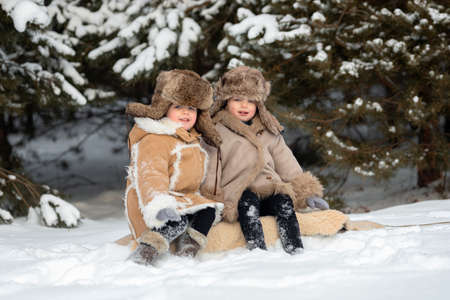 Two cute kids in winter Russian folk clothes like in a fairy taleの写真素材