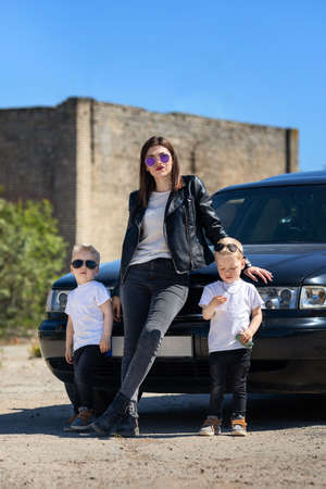 Mom and the twins in leather jackets and sunglasses.A bold and cool family imageの写真素材