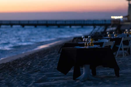 Romantic dinner on the background of sunset on the seashoreの写真素材