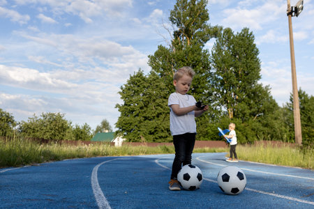 Twin brothers are playing on a walk.の写真素材