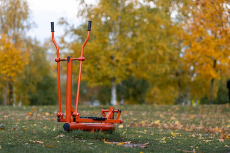 Bright colors of autumn in the city park.Orange sports simulatorの写真素材