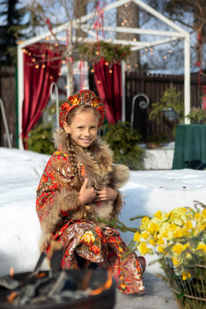 A blonde girl in a national Russian costume on the Maslenitsa holidayの写真素材