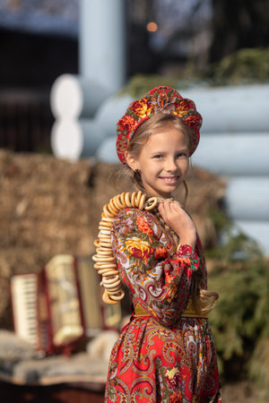 A beautiful russian girl in a national costume made of a fur cape and kokoshnikの写真素材