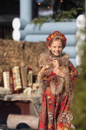 A beautiful russian girl in a national costume made of a fur cape and kokoshnikの写真素材