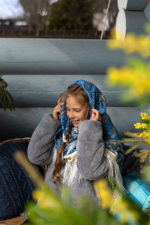 A beautiful Russian girl in a fur coat and a headscarfの写真素材