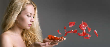 The girl with petals of a roseの写真素材