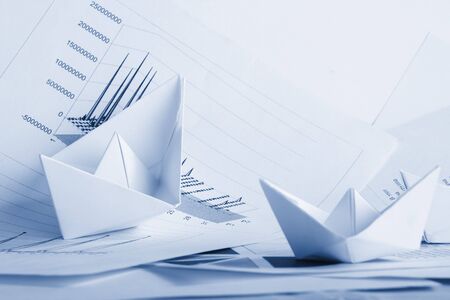 Business concept, paper boat and documentsの写真素材