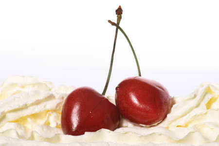 cream, cherries on a white backgroundの写真素材
