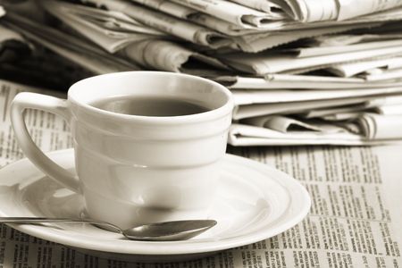 Cup  coffee on a morning paper business news