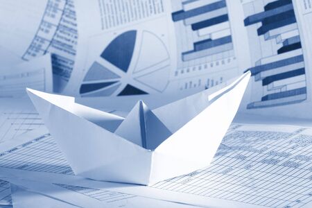 Business concept, paper boat and documentsの写真素材