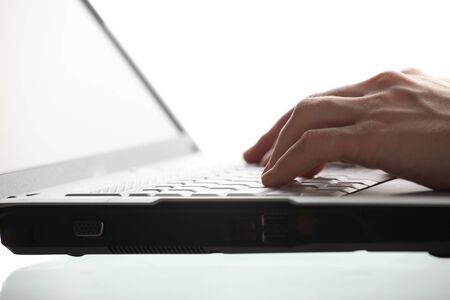 Close-up of  hand touching computer keys during work