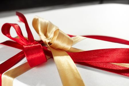 Big red, gold bow on white background