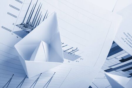 Business concept, paper boat and documentsの写真素材