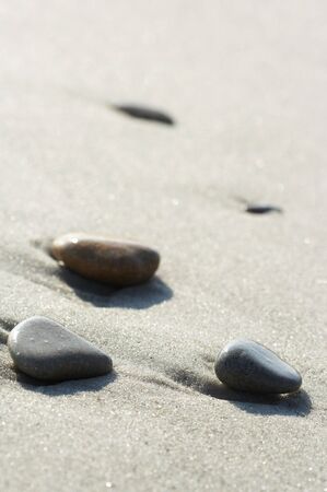 Stones on sand at the sea, a pebbleの写真素材