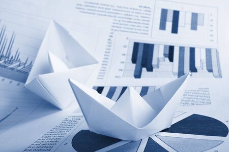 Business concept, paper boat and documentsの写真素材