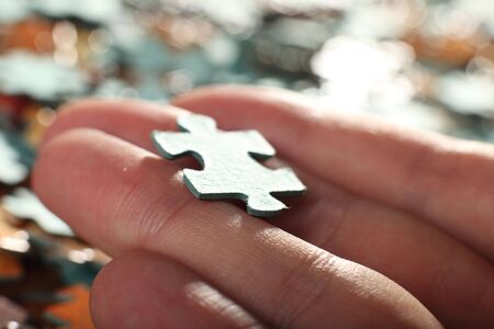The hand holds puzzle on a backgroundの写真素材