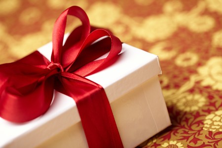 Gift decorated with a tape and a bowの写真素材
