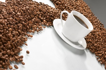 Cup with coffee, costing on coffee grainの写真素材