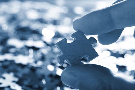 The hand holds puzzle on a background