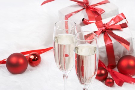 Christmas gift with tapes and a bottle of champagneの写真素材